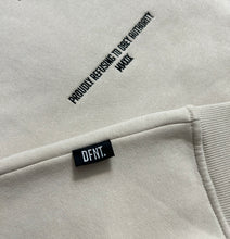 Load image into Gallery viewer, A close up of the amazing design on the Oversized DFNT. Eternity Hoodies.  This close up shows the precision embroidery in black on an off-white garment.  it also shows the subtle DFNT. tag that is sewn into the seem for that extra touch of class and branding. 