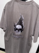 Load image into Gallery viewer, A photo showing the back of a unisex t-shirt.  The shirt has a big bold print on the back of a skull in flames. Underneath the skull is the defiant tag line &#39;Proudly Refusing To Obey Authority&#39; with the The Defiant Co logo under that. The t-shirt is faded grey in colour.