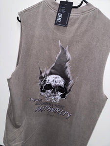 A photo showing the back of a unisex sleeveless t-shirt.  The shirt has a big bold print on the back of a skull in flames. Underneath the skull is the defiant tag line 'Proudly Refusing To Obey Authority' with the The Defiant Co logo under that. The sleeveless is faded grey in colour.