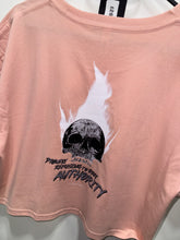 Load image into Gallery viewer, A photo showing the back of a female fit cropped t-shirt.  The shirt has a big bold print on the back of a skull in flames. Underneath the slull is the defiant tag line &#39;Proudly Refusing To Obey Authority&#39; with the The Defiant Co logo under that. The shirt is a blush in colour.