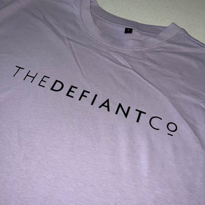 A photo showing an oversized The Defiant Co T-Shirt.  The shirt has the famous ‘The Defiant Co’ logo across the front of the chest.  The shirt has a round neck and is oversized.  This particular version is the colour lilac.
