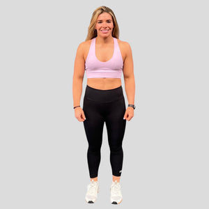 A photo showing the front of the amazing The Defiant Co Infinity Sports Bra.  The bra has a unique crossed back with The Defiant Co logo across both straps giving it a really standout look. The front is plain and simple giving it a really classy look. The colour is lilac.