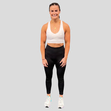 Load image into Gallery viewer, A photo showing the front of the amazing The Defiant Co Infinity Sports Bra.  The bra has a unique crossed back with The Defiant Co logo across both straps giving it a really standout look. The front is plain and simple giving it a really classy look. The colour is white.