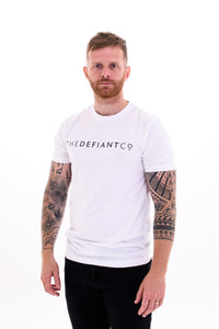 A guy with visible tattoos wearing The Defiant Co short sleeved t-shirt.  The t-shirt is 100% cotton and is extremely high quality making it a staple for the gym and beyond.  The famous The Defiant Co logo is embossed across the centre of the chest and the colour of the tee is white.