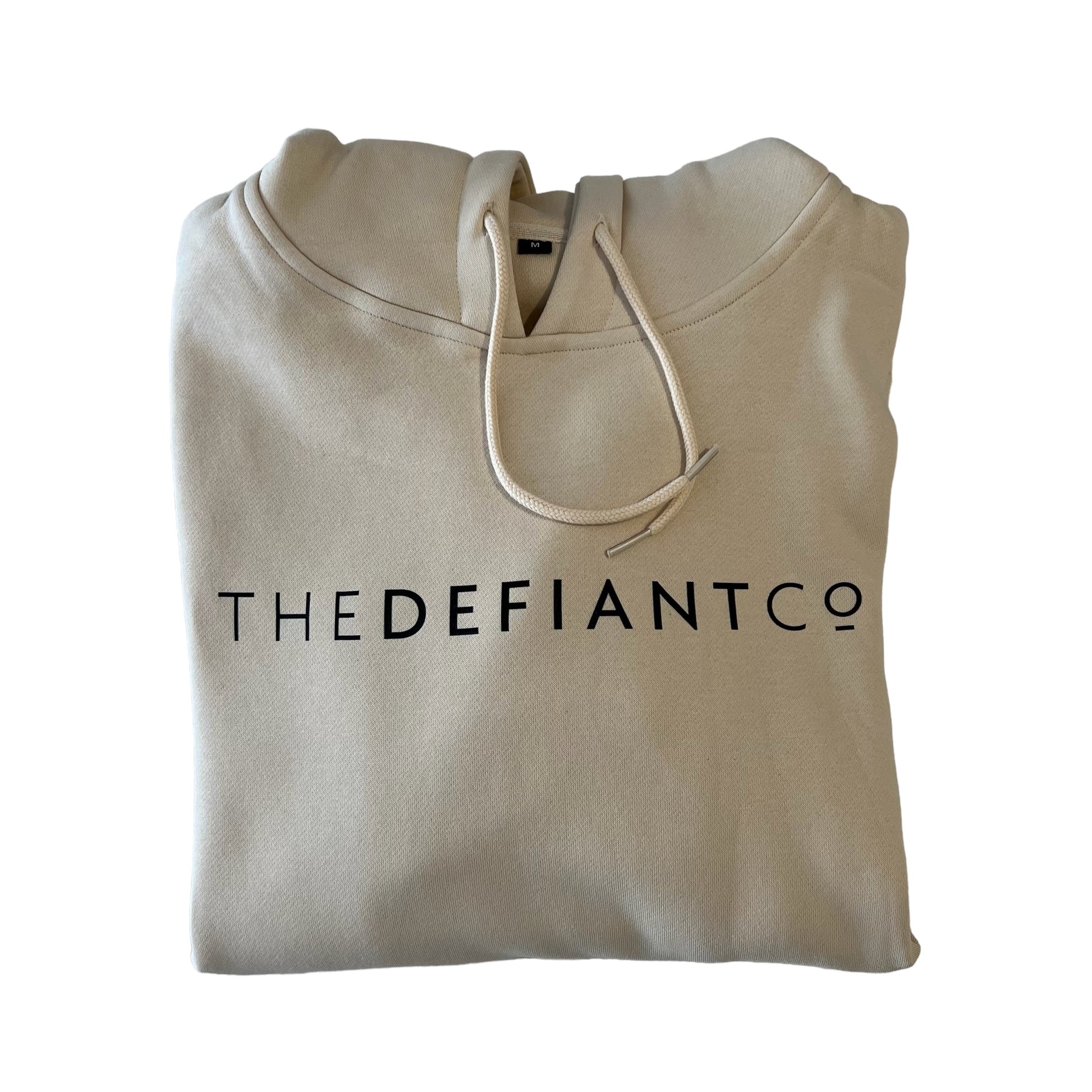 A photo of a standard fit, unisex The Defiant Co Hoodie.  The hoodie has draw strings and a pouch pocket on the front as per all standard designs.  The hoodie has the famous The Defiant Co logo across the front of the chest and is plain on the back.  The colour is sand. 