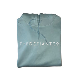 A photo of a standard fit, unisex The Defiant Co Hoodie.  The hoodie has draw strings and a pouch pocket on the front as per all standard designs.  The hoodie has the famous The Defiant Co logo across the front of the chest and is plain on the back.  The colour is sky blue.