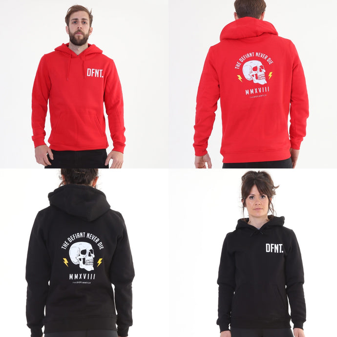 A photo collage showing the design of the two variations of The Defiant Never Die hoodie.  The colour options are black and red.  The vests bare slightly cropped and slightly oversized giving them a floaty feel.  The back design has the bold skull and lightening design with The Defiant Never Die slogan across the top and The Defiant Co along the bottom along with the date Defiant was formed.  The front has the DFNT. Logo to the left breast.