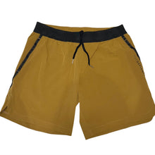 Load image into Gallery viewer, A photo of the best selling The Defiant Co Performance Shorts.  The shorts have a black elasticated waistband with draw strings and have The Defiant Co logo down the left leg.  The shorts have two pockets, one either side and are the colour gold.